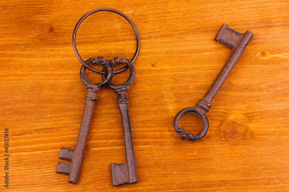 a bunch of antique keys on wooden background a bunch of antique keys on wooden background