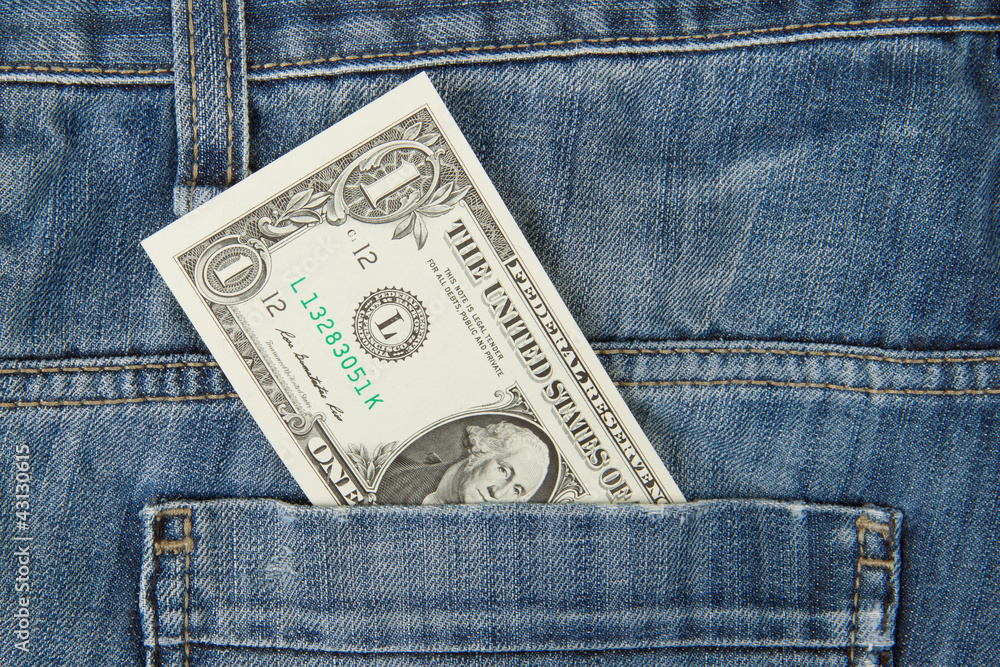 Macro shot of trendy jeans with american 1 dollar bill Macro shot of trendy jeans with american 1 dollar bill