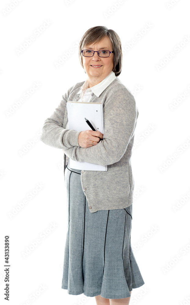 Senior woman holding spiral notepad and pen Senior woman holding spiral notepad and pen