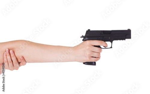 woman's hand holding a gun