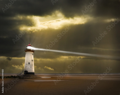 lighthouse in a storm with beam shining to sea