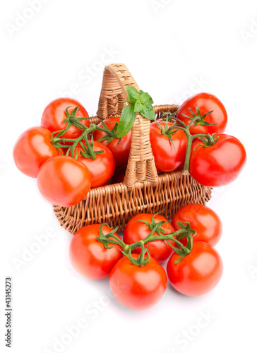 Wicker basket full of delicious tomatoes