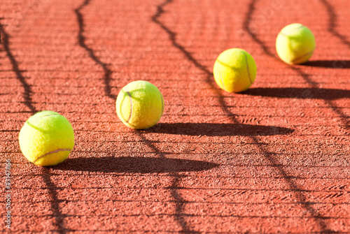 tennis balls on court © lusia83