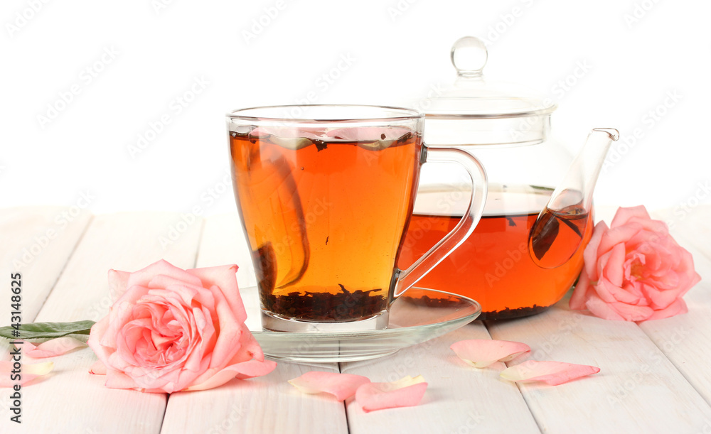 teapot and cup of tea with roses on white wooden table teapot and cup of tea with roses on white wooden table