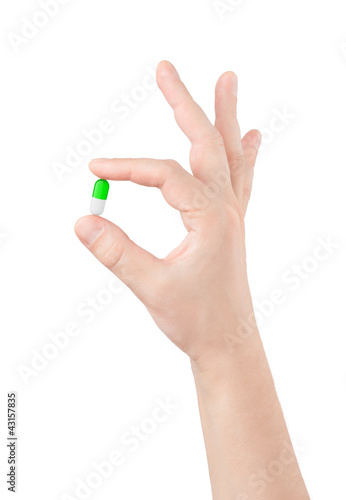 pill in hand on white background