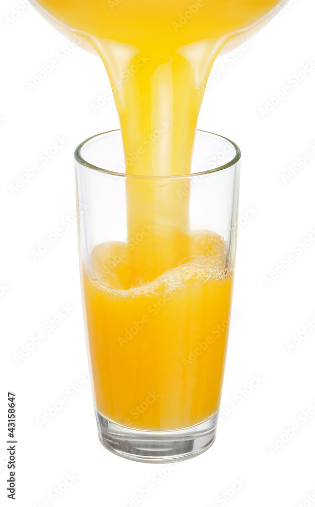 Fresh juice is poured into a glass Fresh juice is poured into a glass