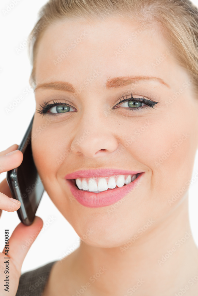 Woman smiling calling with her smartphone Woman smiling calling with her smartphone