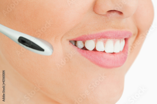 Close-up of a woman smiling working in call center