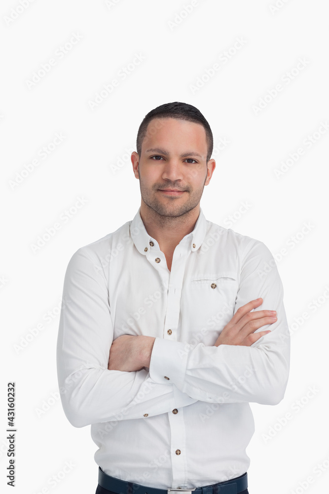 Man standing up and crossing his arms Man standing up and crossing his arms