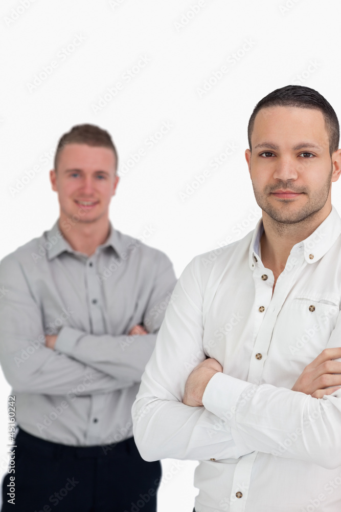 Two men crossing their arms as they stand up Two men crossing their arms as they stand up