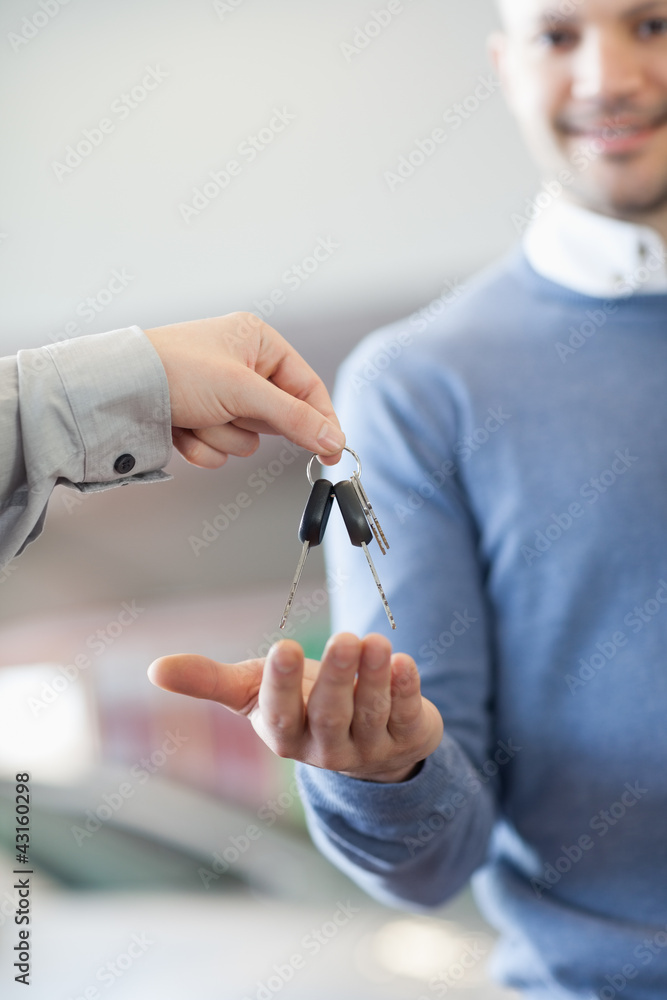 Customer receiving keys from a car dealer Customer receiving keys from a car dealer