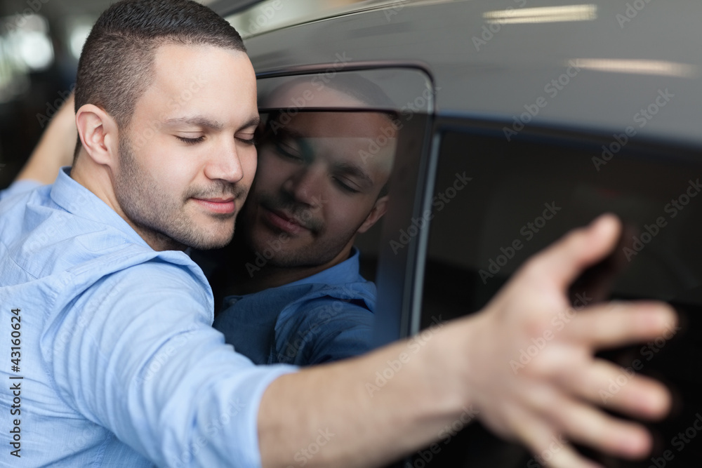 Man hugging on a car Man hugging on a car