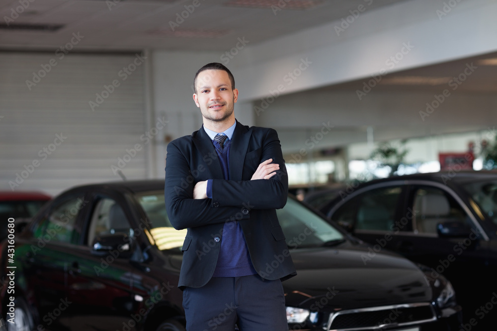 Man standing in front of a car Man standing in front of a car
