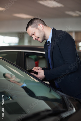 Salesman looking inside the car