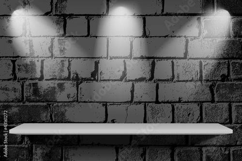 Shelf with light on brick vintage wall