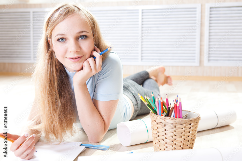 teenage girl lying on floor drawing teenage girl lying on floor drawing