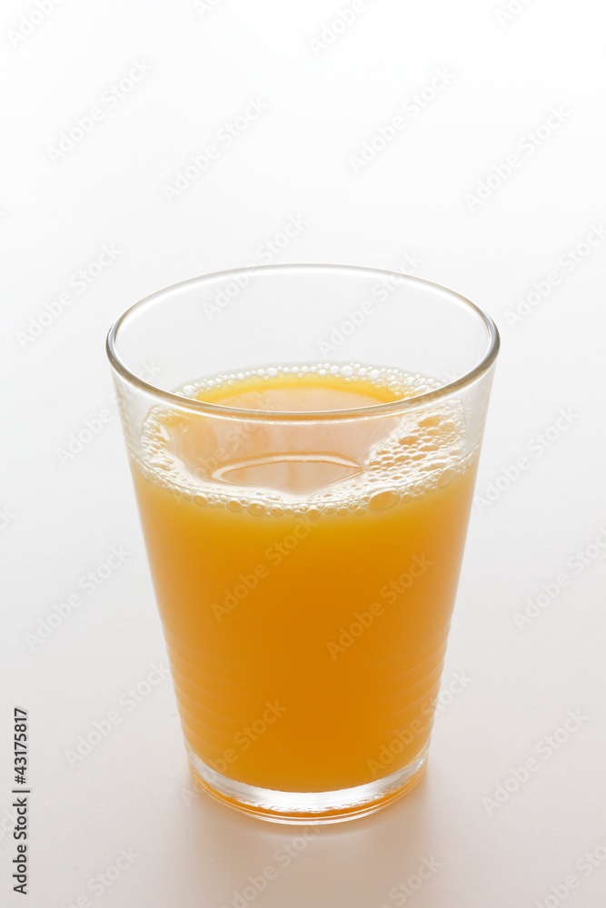 Orange juice in a glass with a white background