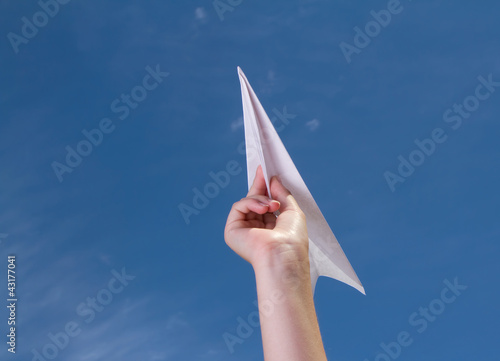 child holding a paper airplane