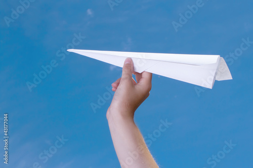 child holding a paper airplane