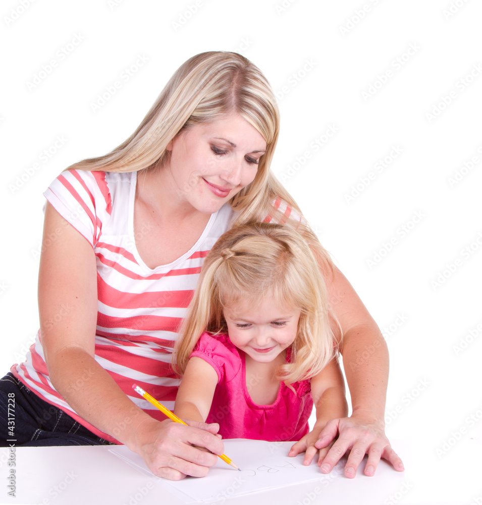 mother helping daughter write alphabet