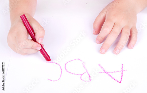 Prechool age child writing alphabet