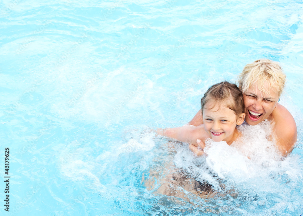 woman and  girl swimming in the pool