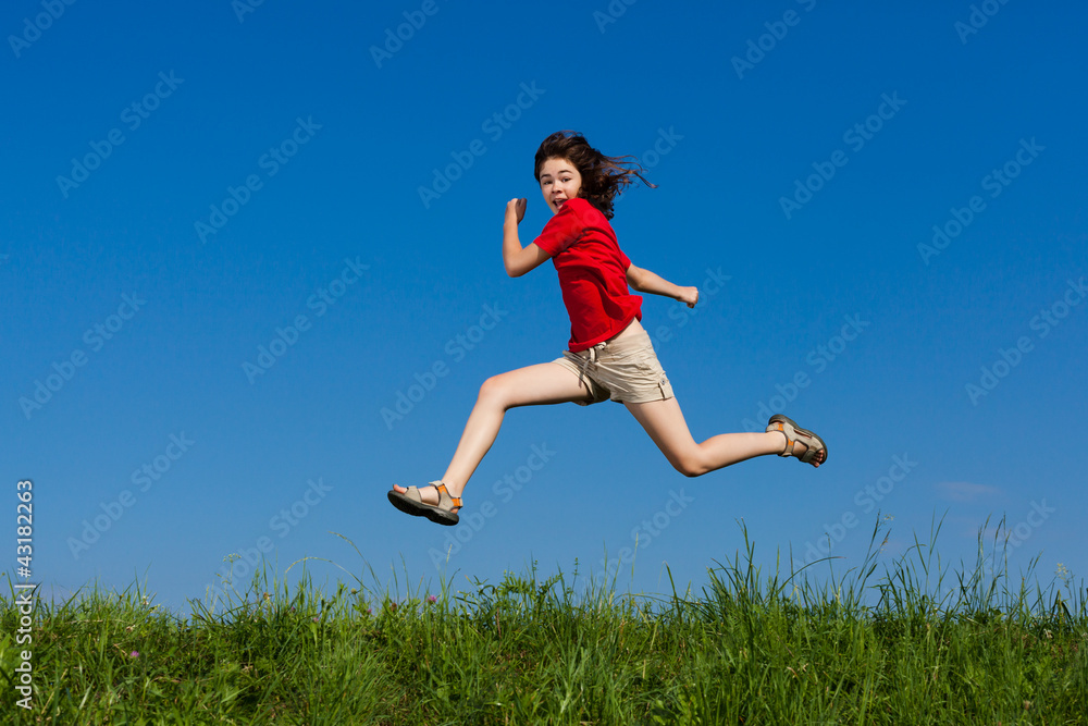 Girl jumping, running against blue sky Girl jumping, running against blue sky