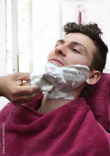 Portrait of young man at barber shop