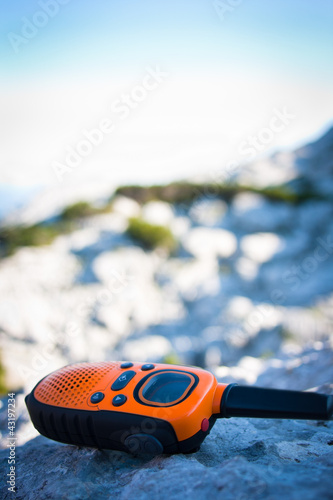 Closeup of a walkie-talkie laid aside on a rock 