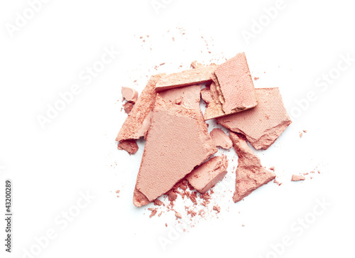 Фотография pale pink blusher crushed on white background