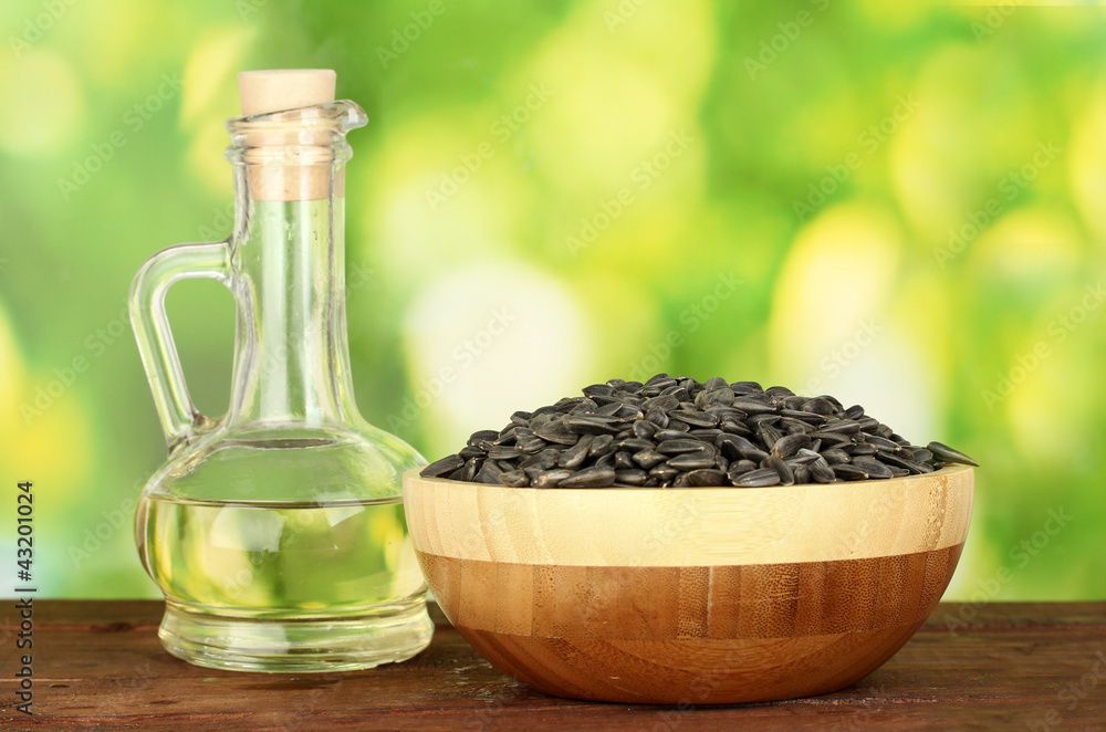 sunflower oil in small decanter with sunflower seeds sunflower oil in small decanter with sunflower seeds