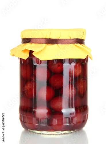 Jar with canned cherries isolated on white