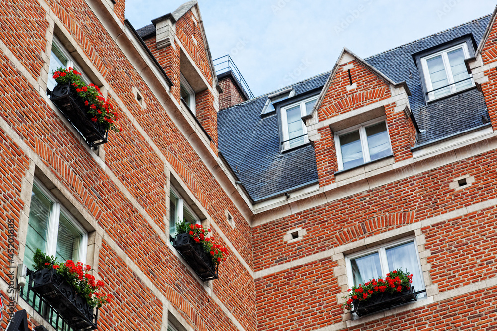 beautiful house with the balconies decorated with flowers