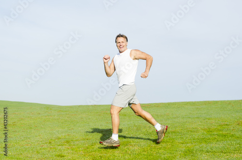 happy smiling man running. © Andrew Lever