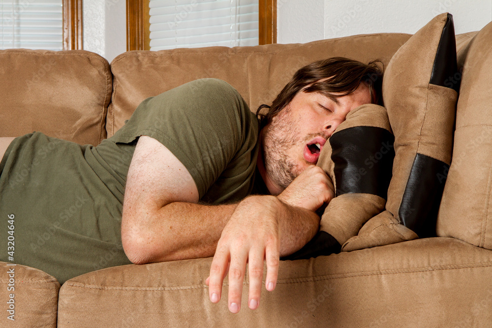 Man taking a quick nap on the couch - obrazy, fototapety, plakaty 