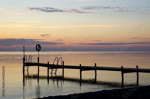 Bath bridge with lifebouy in sunset and calm water