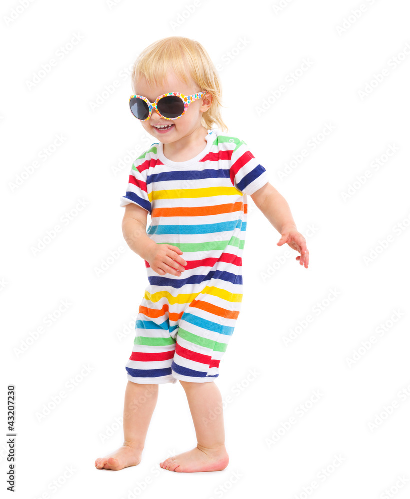 Happy baby in swimsuit and sunglasses dancing Happy baby in swimsuit and sunglasses dancing