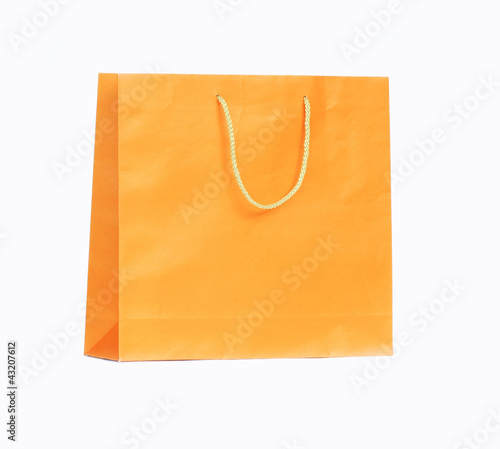 Orange paper bag isolated on white background