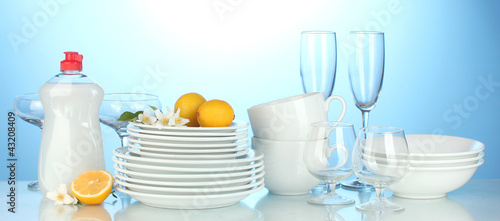 empty clean plates, glasses and cups with dishwashing liquidand