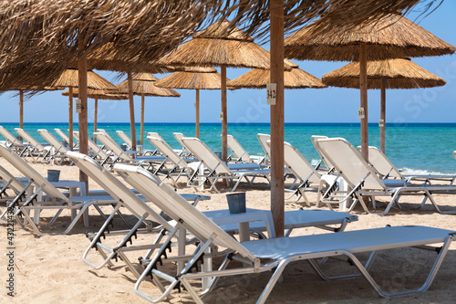 Beautiful beach with deck chairs and umbrellas