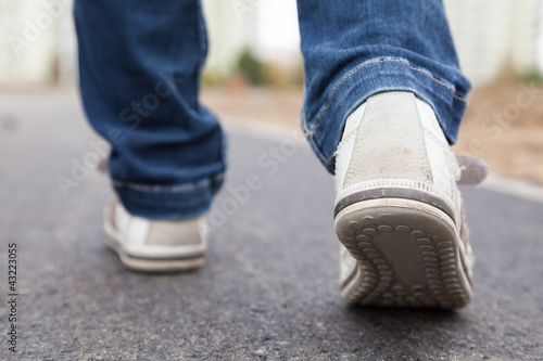 Walking in sport shoes on pavement