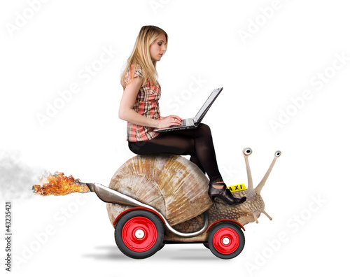 Attractive blond girl with laptop riding on speedy snail photo