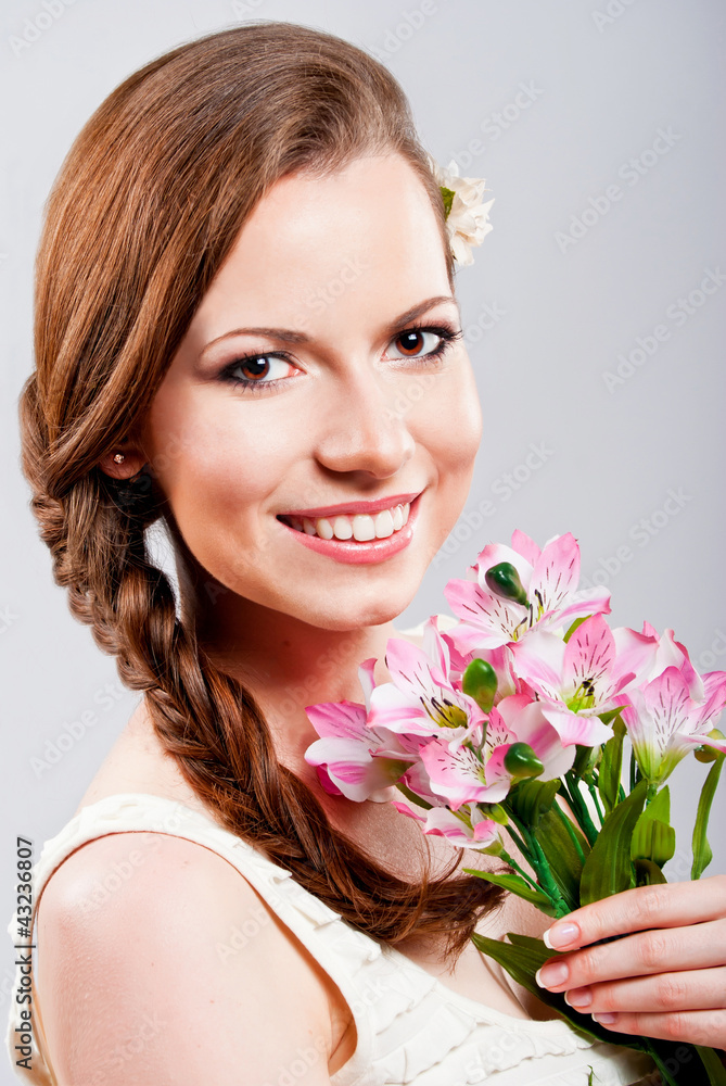 Beautiful young woman with a bouquet of flowers