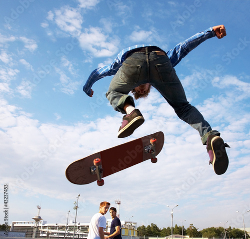 Fototapeta Skater jumps high in air