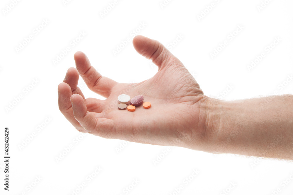 Hand holding pills in an angry or frustrated manner Hand holding pills in an angry or frustrated manner