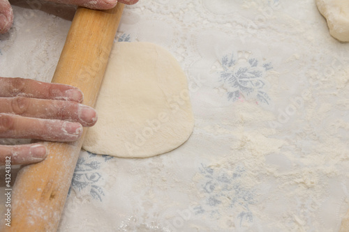 Flour in capacity with dough and rolling pin