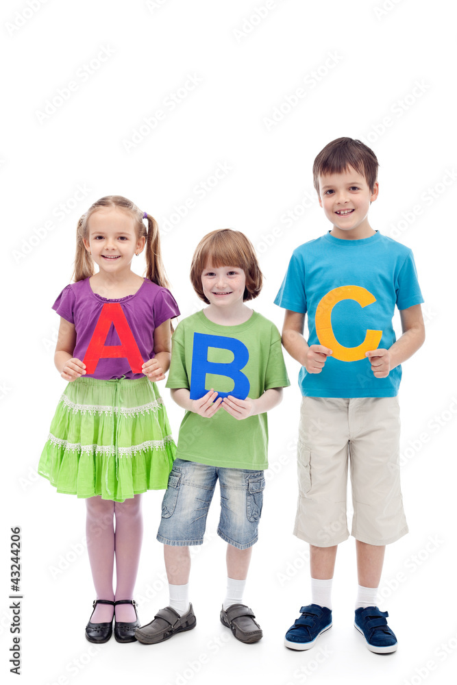 Happy school kids holding large abc letters Happy school kids holding large abc letters