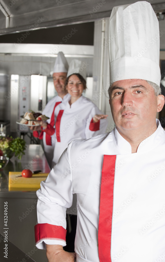 group of young beautiful professional chefs portrait in industri
