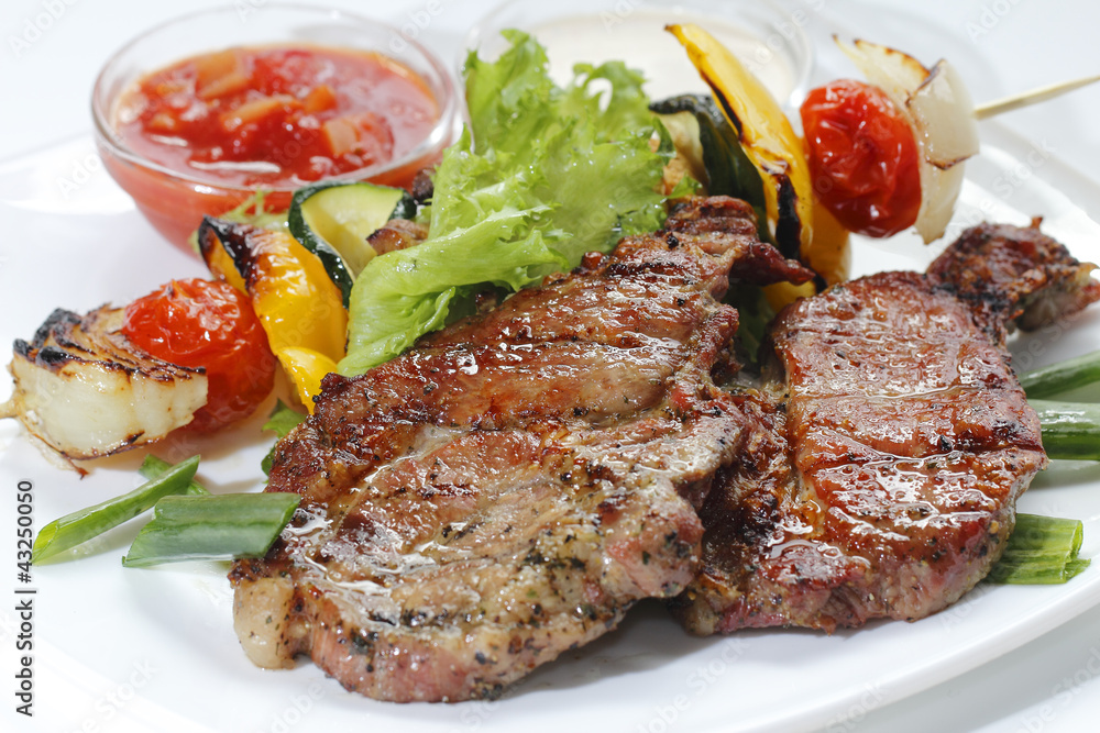 a piece of meat fried with vegetables and sauce a piece of meat fried with vegetables and sauce