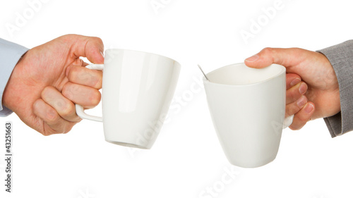 Business partners hands holding cups of coffee